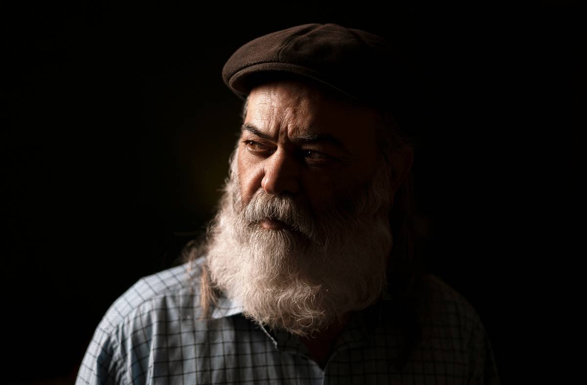 a man with a long white beard wearing a hat