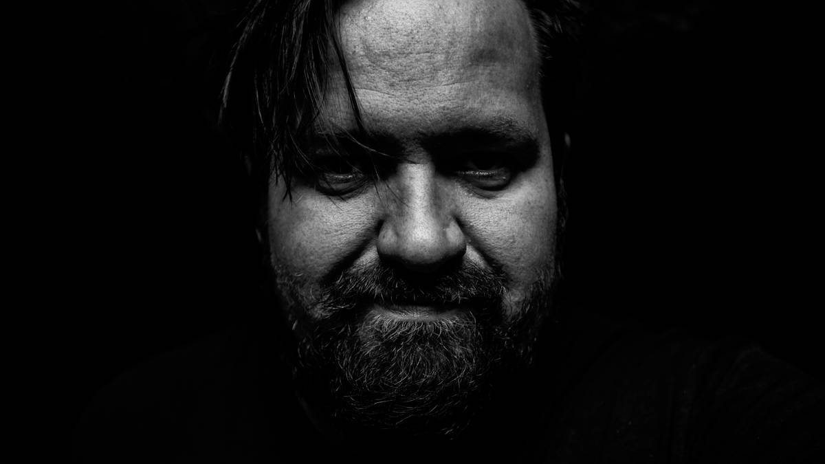 mans face in grayscale photography
