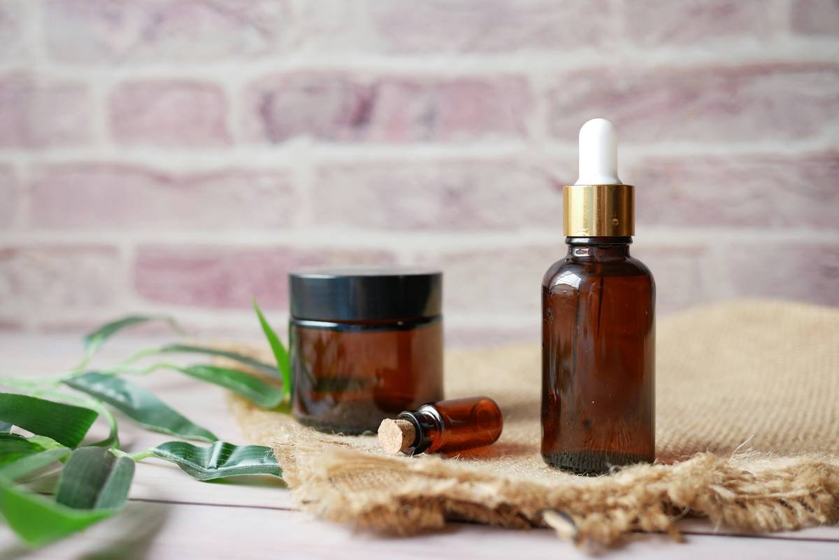 Close-up of beard oils with antioxidant properties being applied to a thick, healthy beard